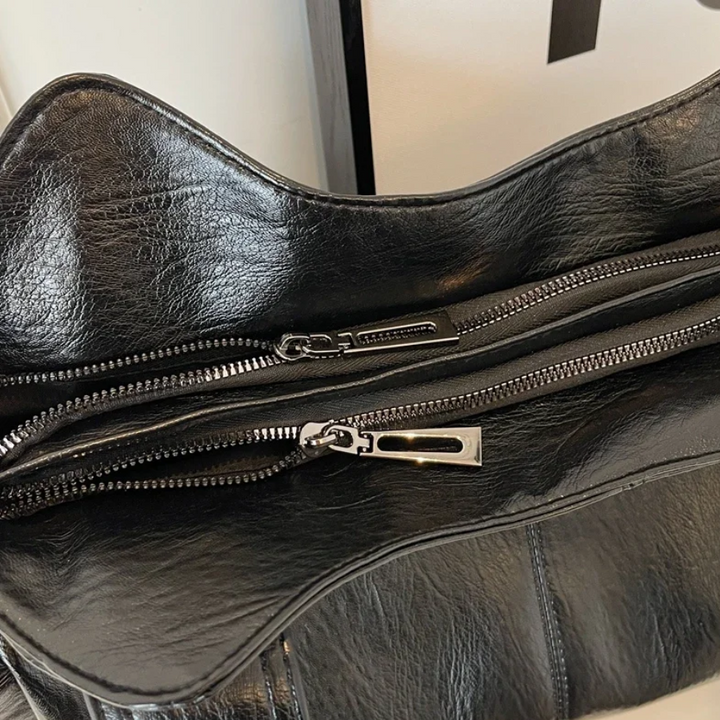 Casual shoulder bag with zippers and adjustable strap