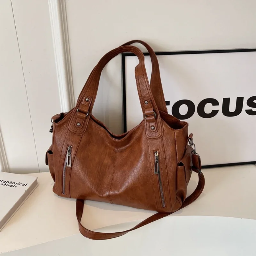 Casual shoulder bag with zippers and adjustable strap