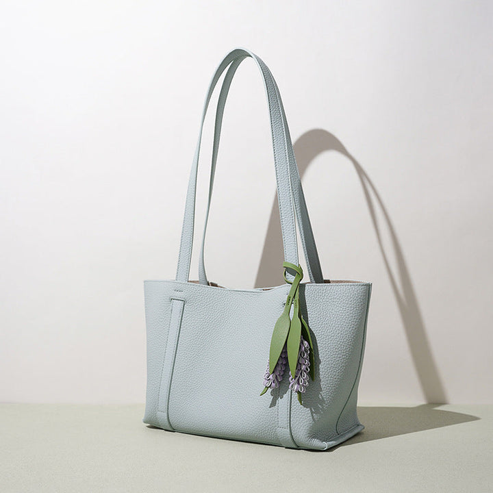 Ladies stylish tote bag with floral pendant