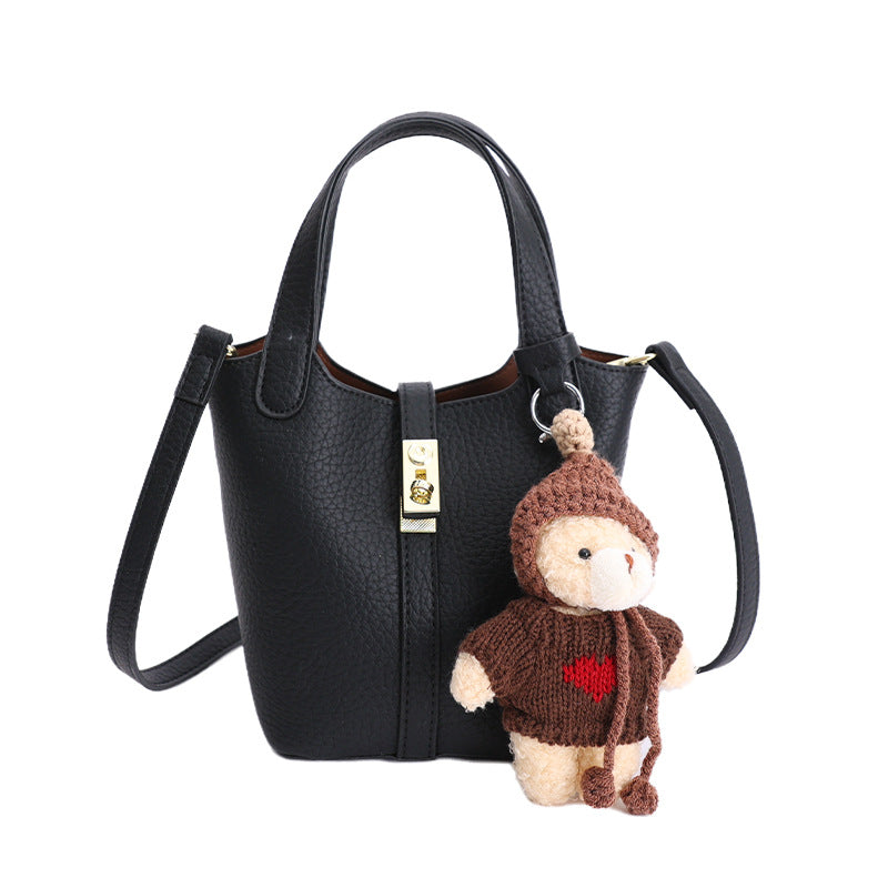 Women's mini handbag with playful animal charm
