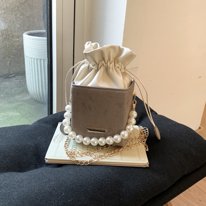 Ladies stylish mini handbag with drawstring and pearl accent
