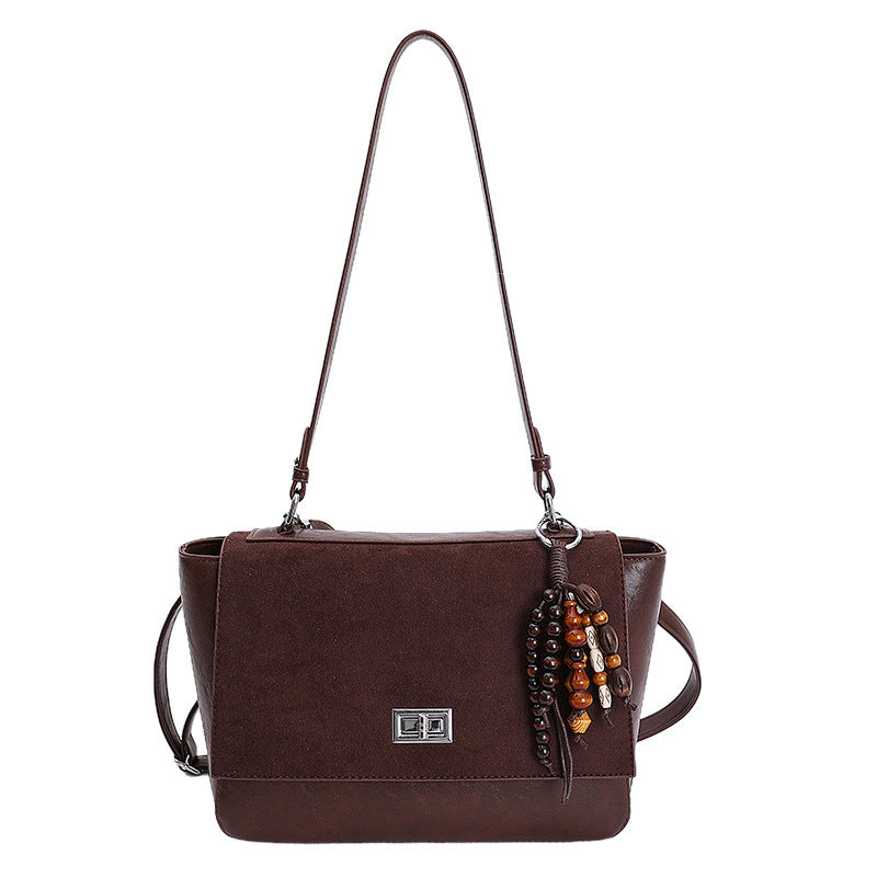 Women's elegant shoulder bag made of high-quality faux leather with playful charm
