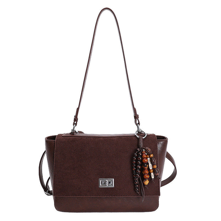 Women's elegant shoulder bag made of high-quality faux leather with playful charm