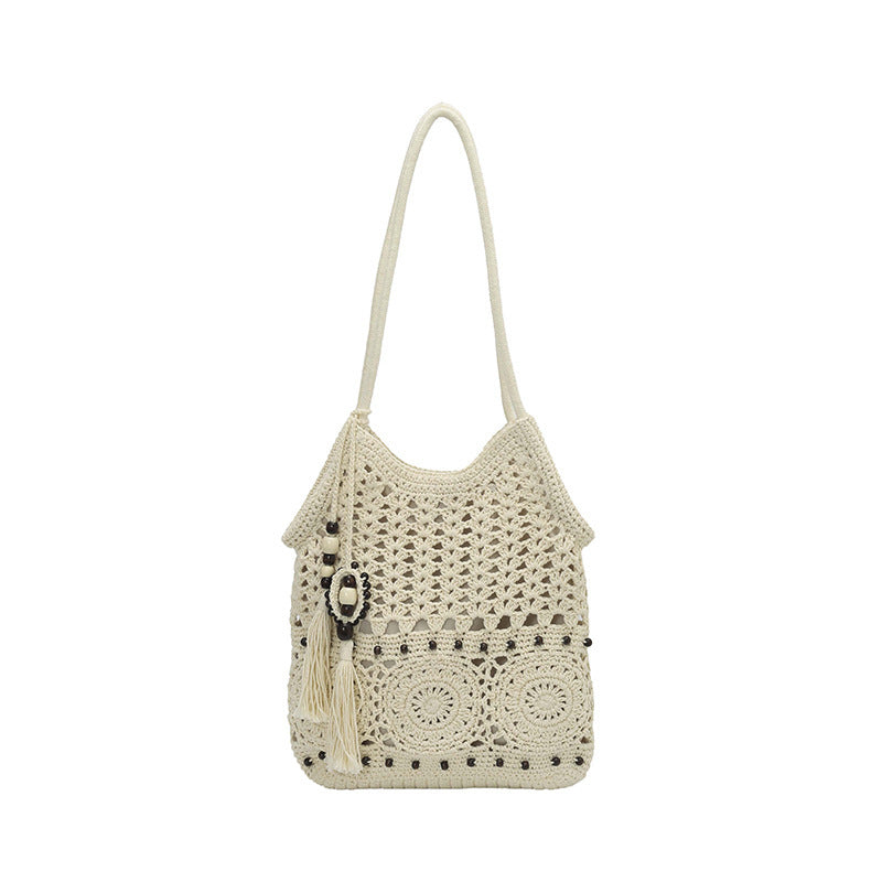 Ladies crocheted shoulder bag with decorative fringes and unique accents