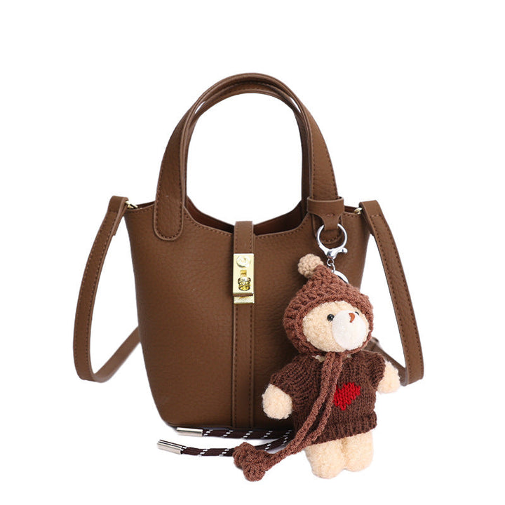 Women's mini handbag with playful animal charm