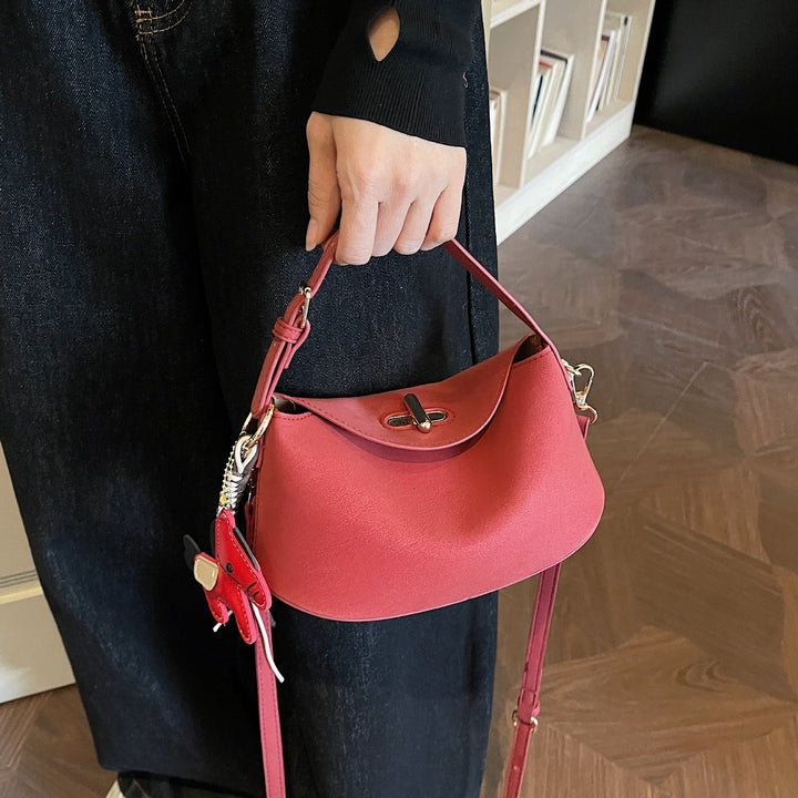 Women's shoulder bag with charming pendant and elegant design