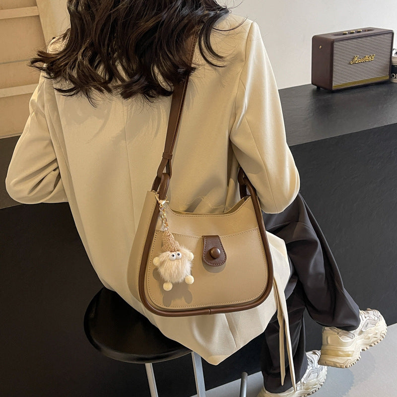 Women's shoulder bag made of high-quality synthetic leather with playful charm