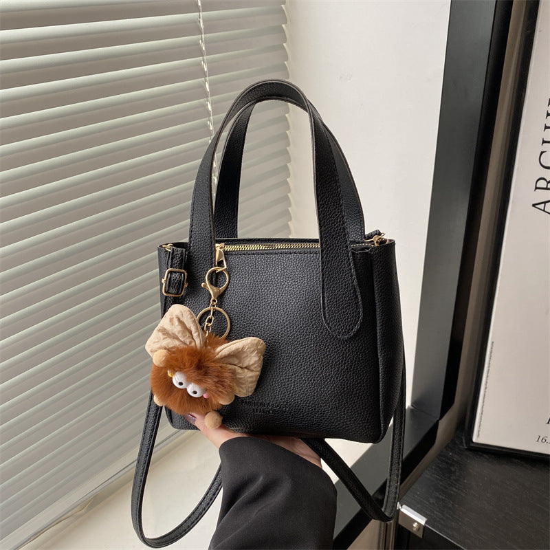 Women’s mini bag with playful animal pendant