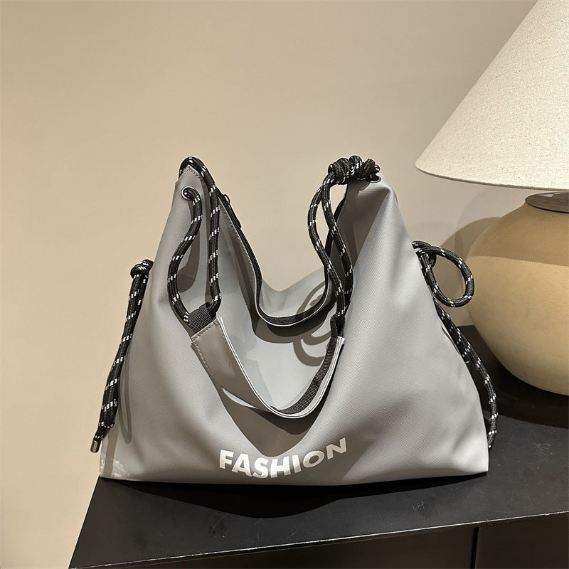 Women's stylish tote bag with braided drawstring