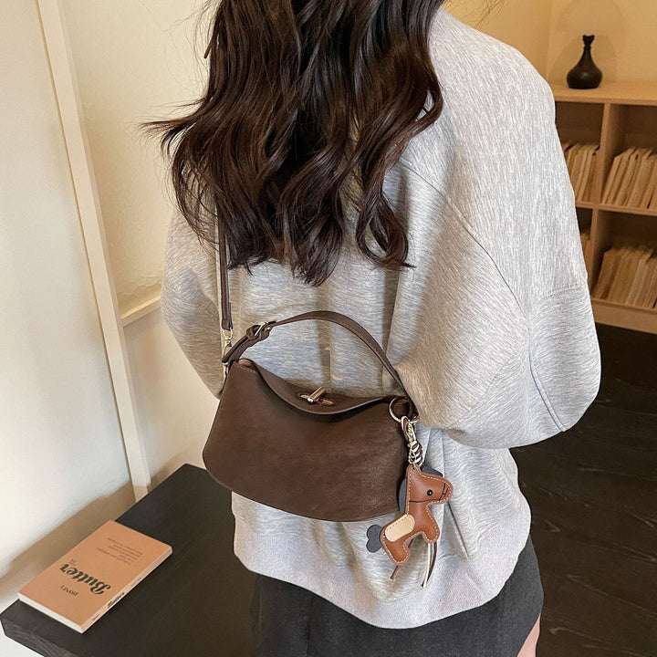 Women's shoulder bag with charming pendant and elegant design