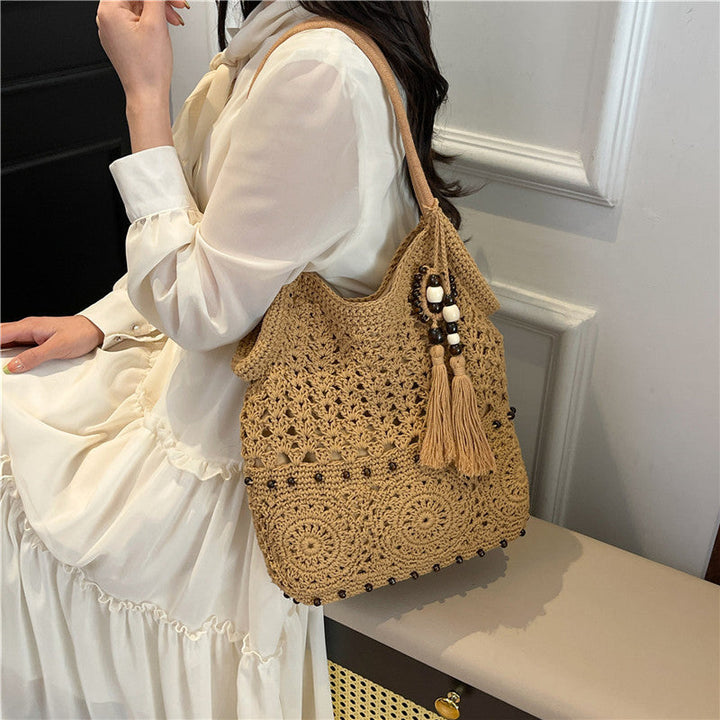 Ladies crocheted shoulder bag with decorative fringes and unique accents