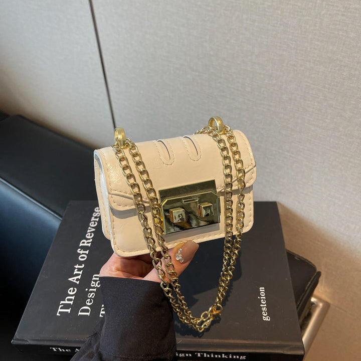 Women's elegant mini handbag with gold fastening mechanism
