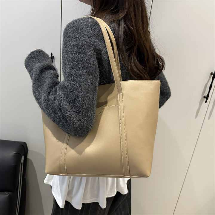 Women's tote bag made of structured synthetic leather with stylish detail