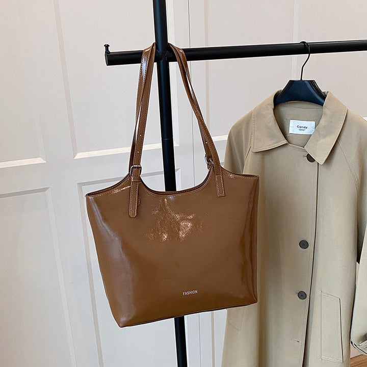 Ladies elegant tote handbag made of high-quality synthetic leather with playful pendant