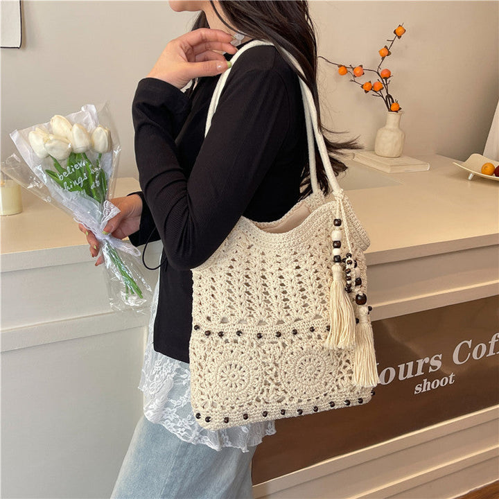 Ladies crocheted shoulder bag with decorative fringes and unique accents