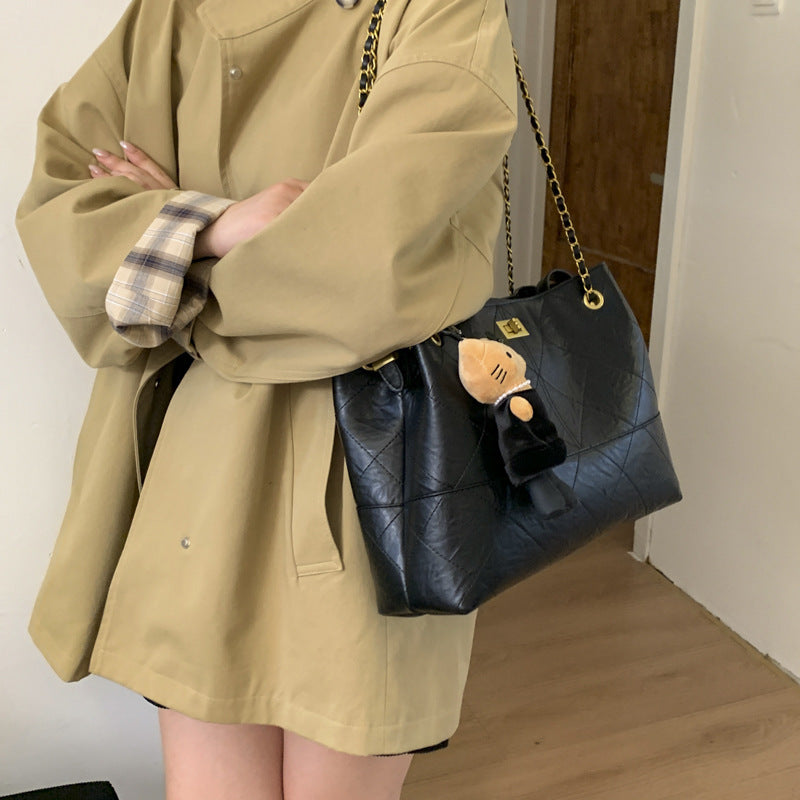 Women's shoulder bag with elegant chain accent and cute pendant