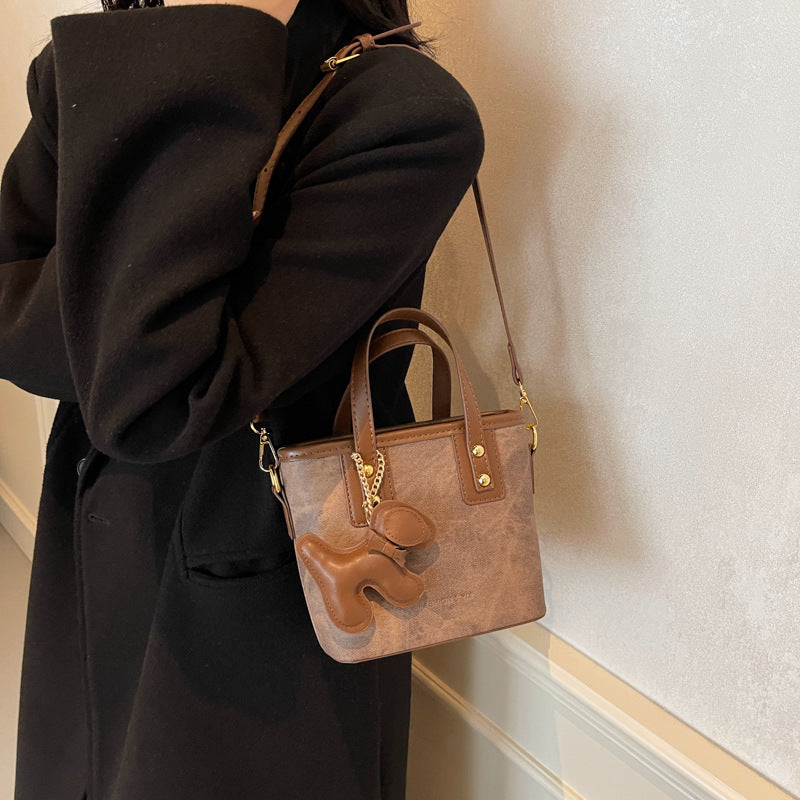 Women's mini bag made of high-quality material with removable funny charm