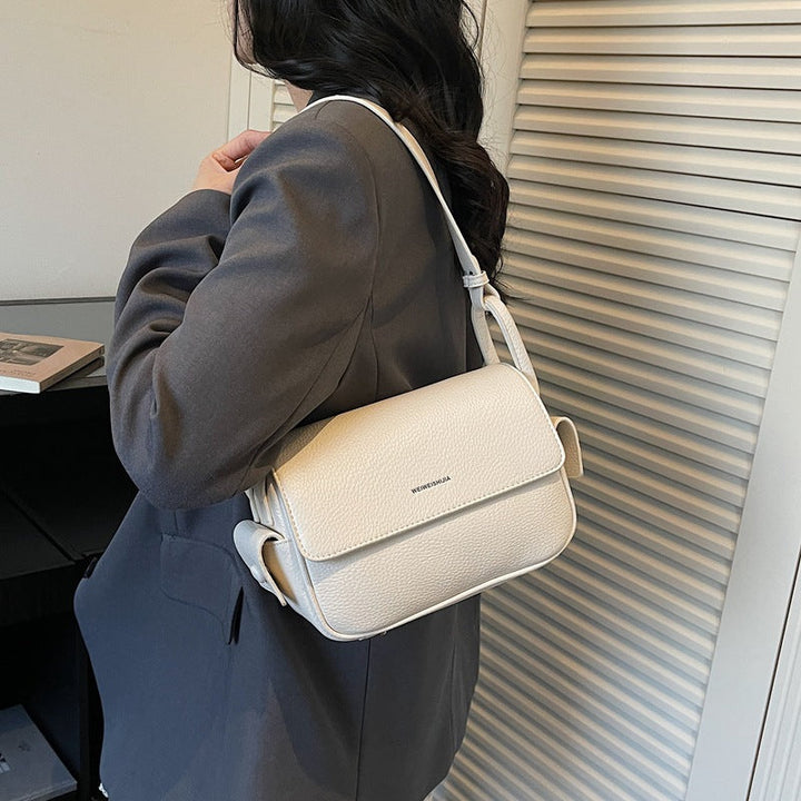 Women’s shoulder bag made of soft, textured leather with adjustable shoulder strap