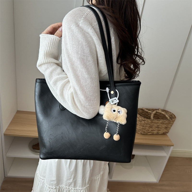 Women's classic tote bag with charming plush toy pendant