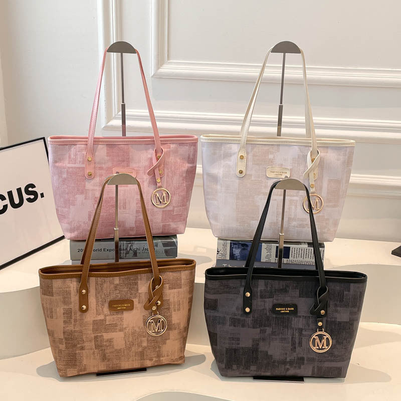 Women's stylish tote bag with textured design and elegant details
