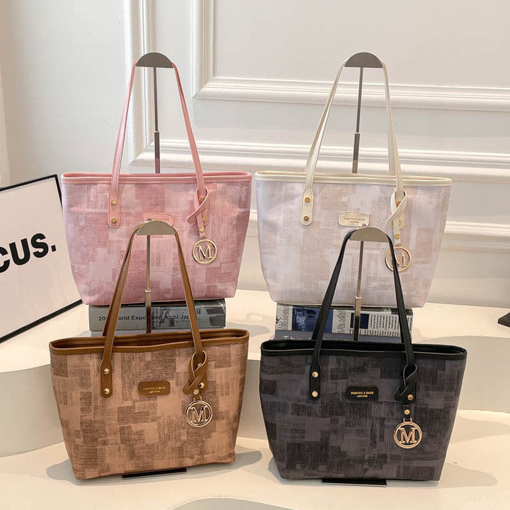 Women's stylish tote bag with textured design and elegant details