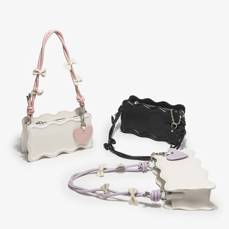 Ladies mini handbag with creative wave pattern and playful pendant
