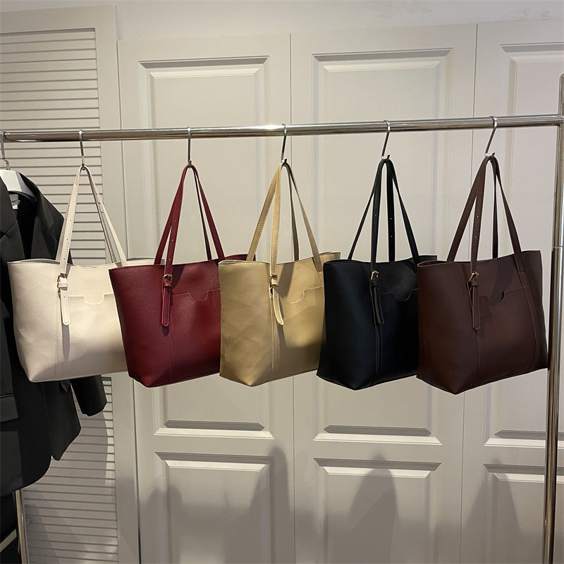 Women's tote bag made of structured synthetic leather with stylish detail