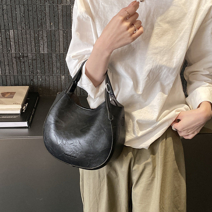 Women's shoulder bag made of high-quality artificial leather with fashionable trim