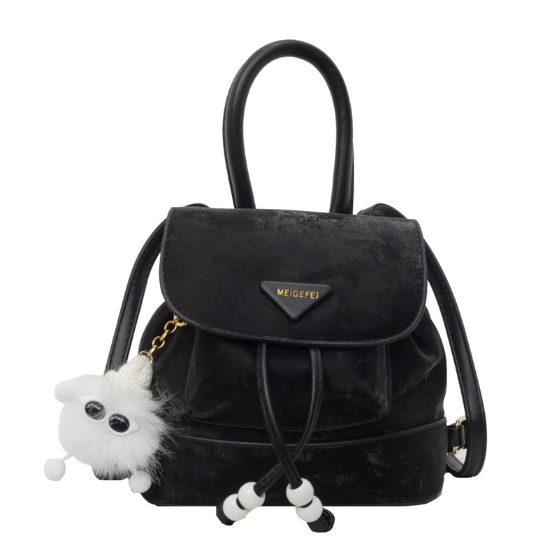 Women's mini backpack with playful design and plush pendant