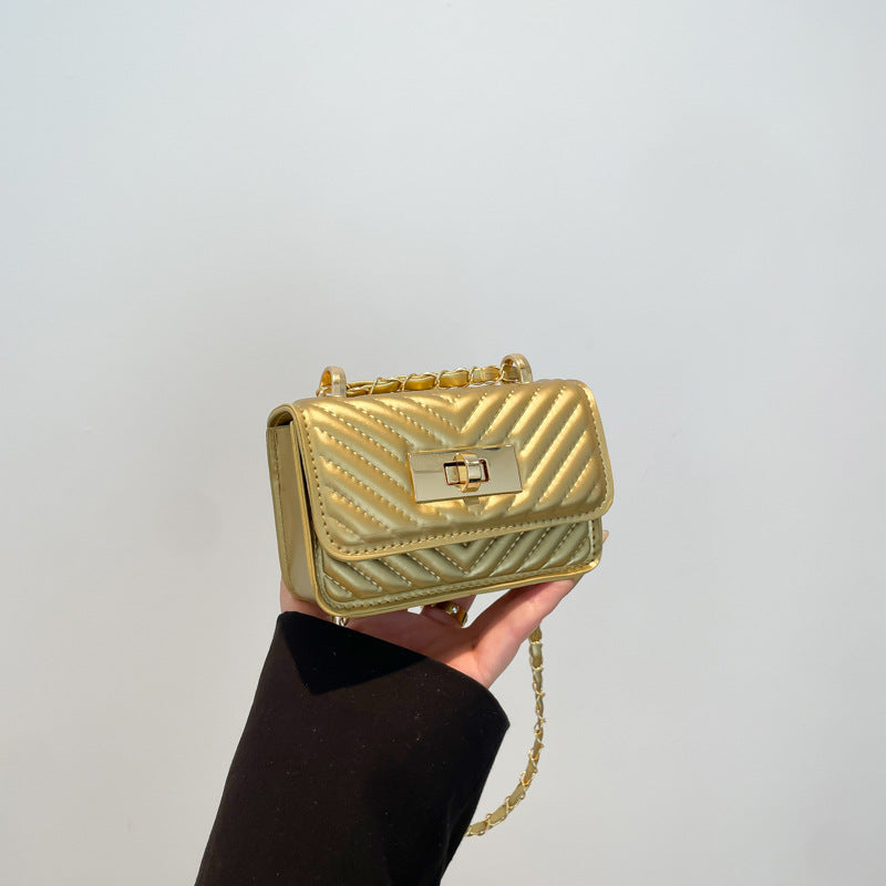 Women’s mini handbag with quilted design and golden clasp