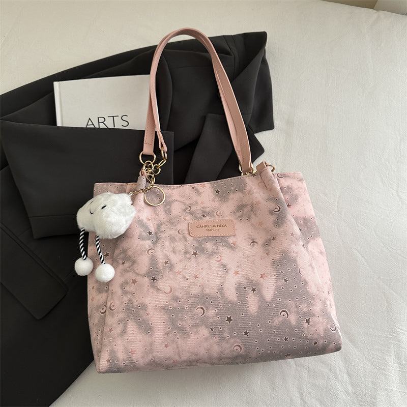 Women’s stylish tote bag with playful pendant