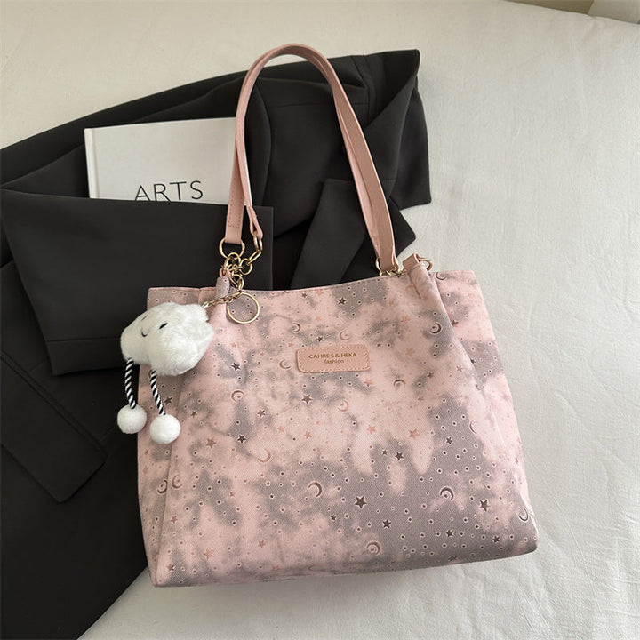 Women’s stylish tote bag with playful pendant