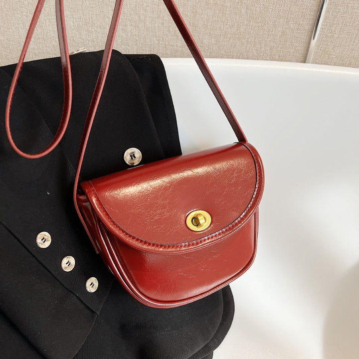 Women's shoulder bag in elegant retro design with golden accents