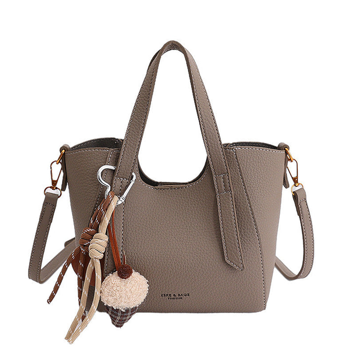 Women's mini handbag in an elegant design with charming pendant