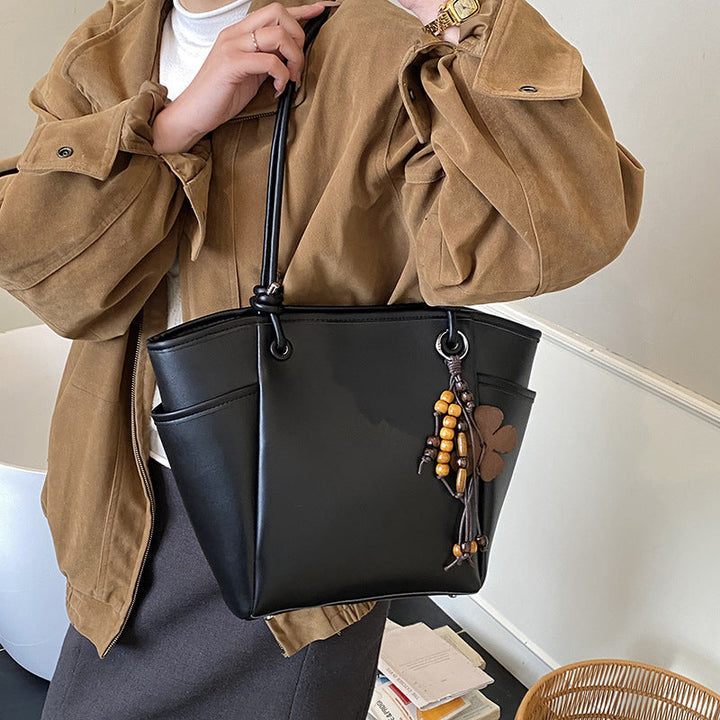 Women's practical shoulder bag with charming appliqués