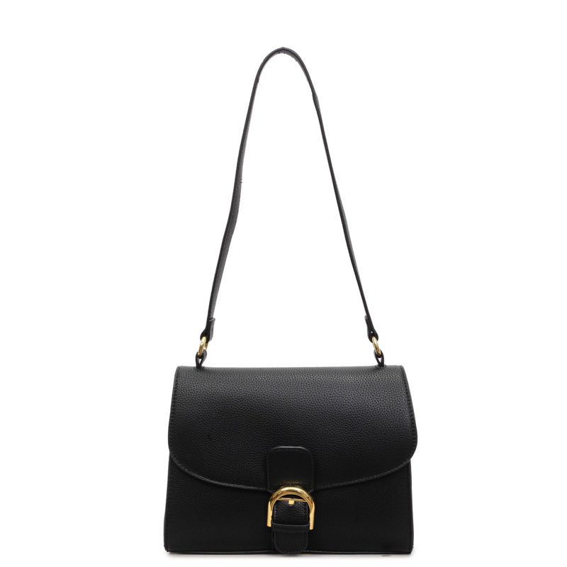 Ladies shoulder bag with elegant flap closure and decorative metal accent