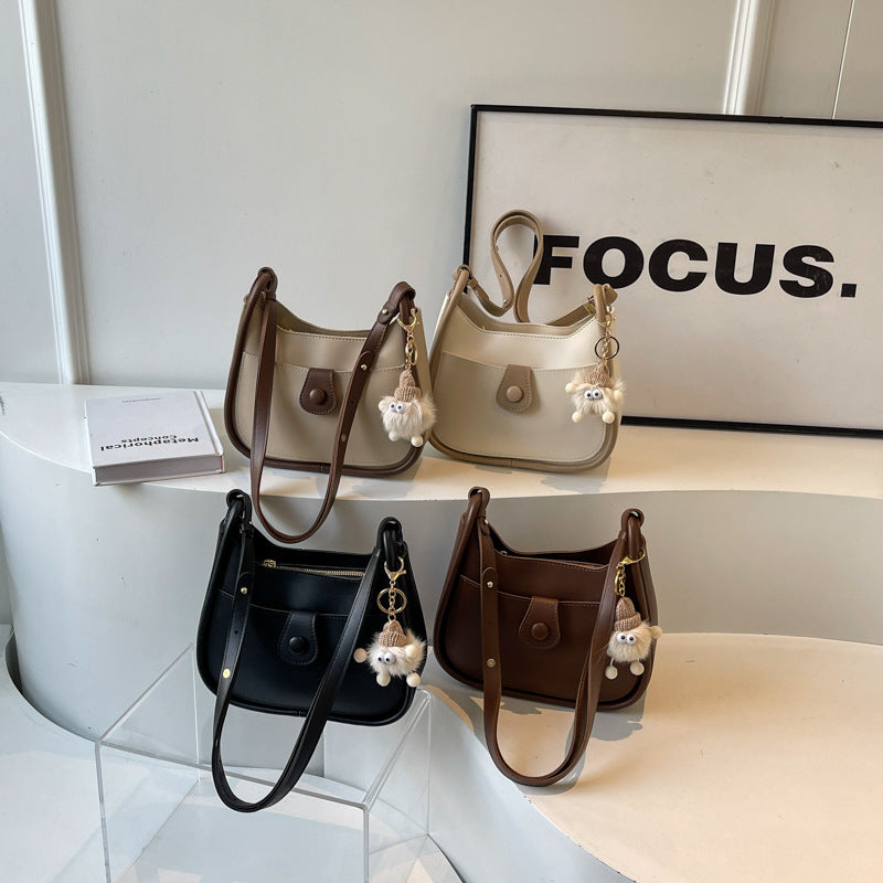 Women's shoulder bag made of high-quality synthetic leather with playful charm