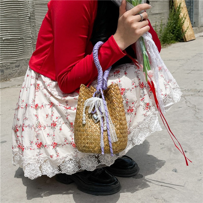 Women's hand-woven shoulder bag with decorative drawstring