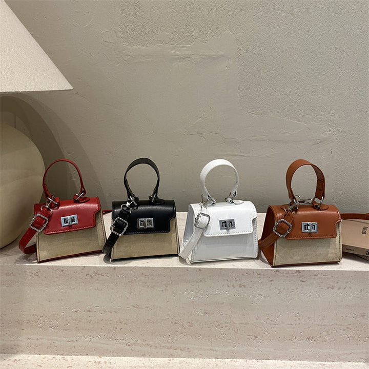 Ladies mini handbag with luxurious leather look and practical carrying handles