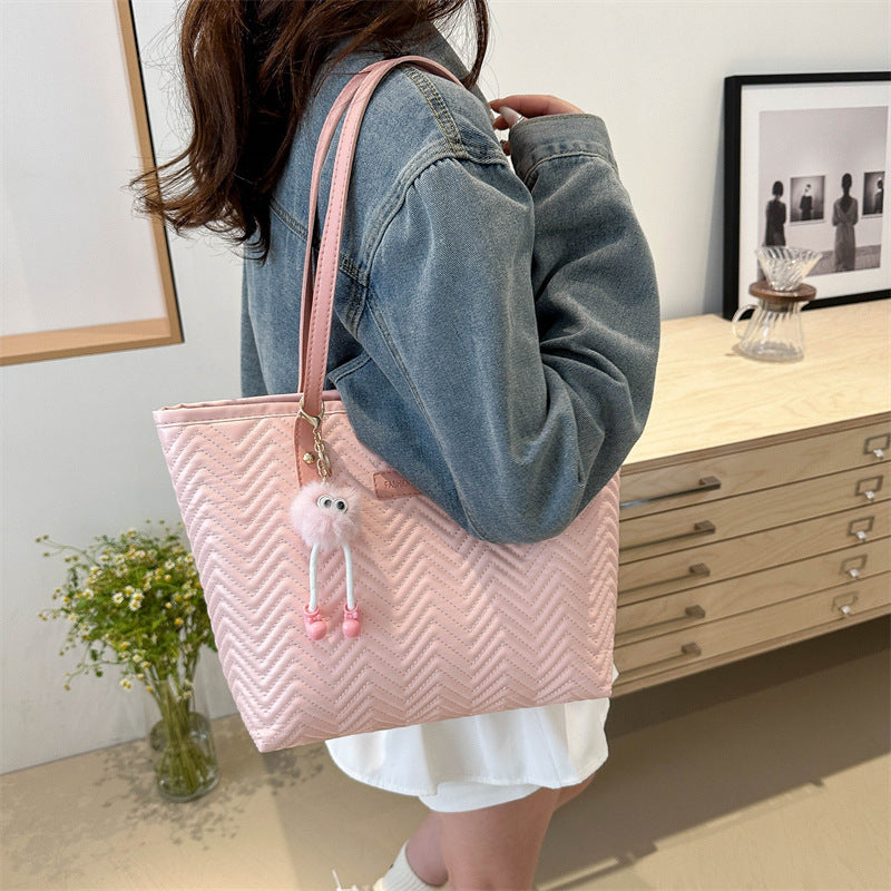 Women's leisure tote bag with textured wave pattern and charming pendant