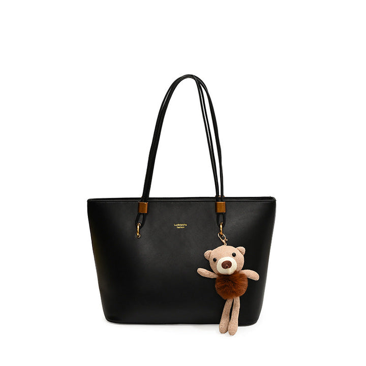 Women's tote bag made of high-quality artificial leather with a charming pendant from