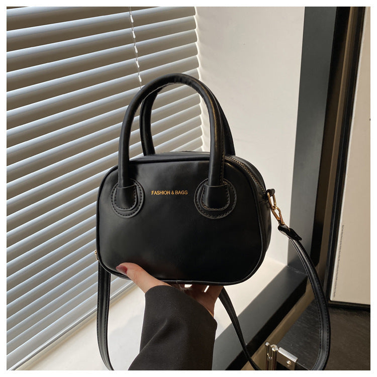 Ladies fashionable handbag with elegant pull handles and removable shoulder strap