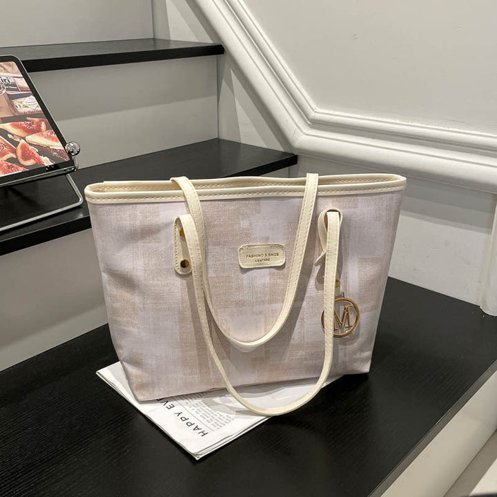 Women's stylish tote bag with textured design and elegant details