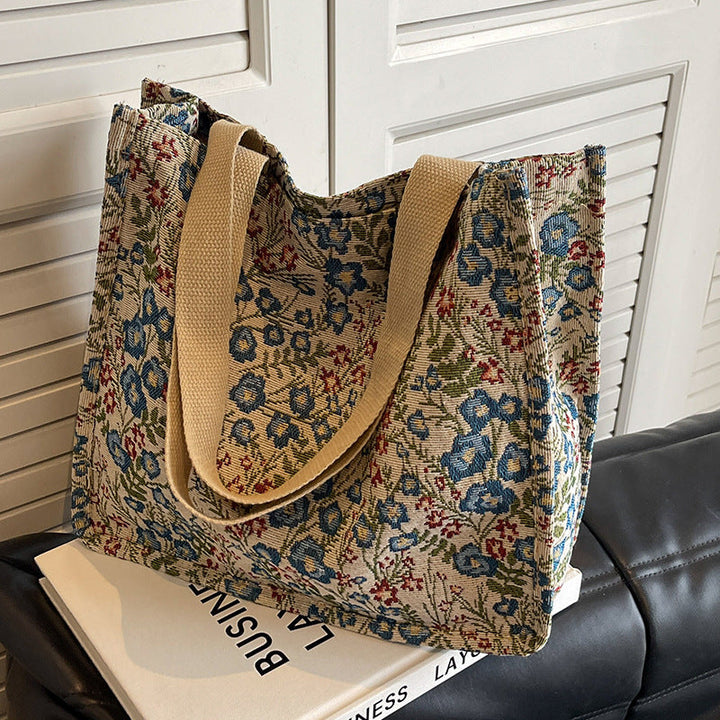 Women's tote bag with floral embroidery design and sturdy handles