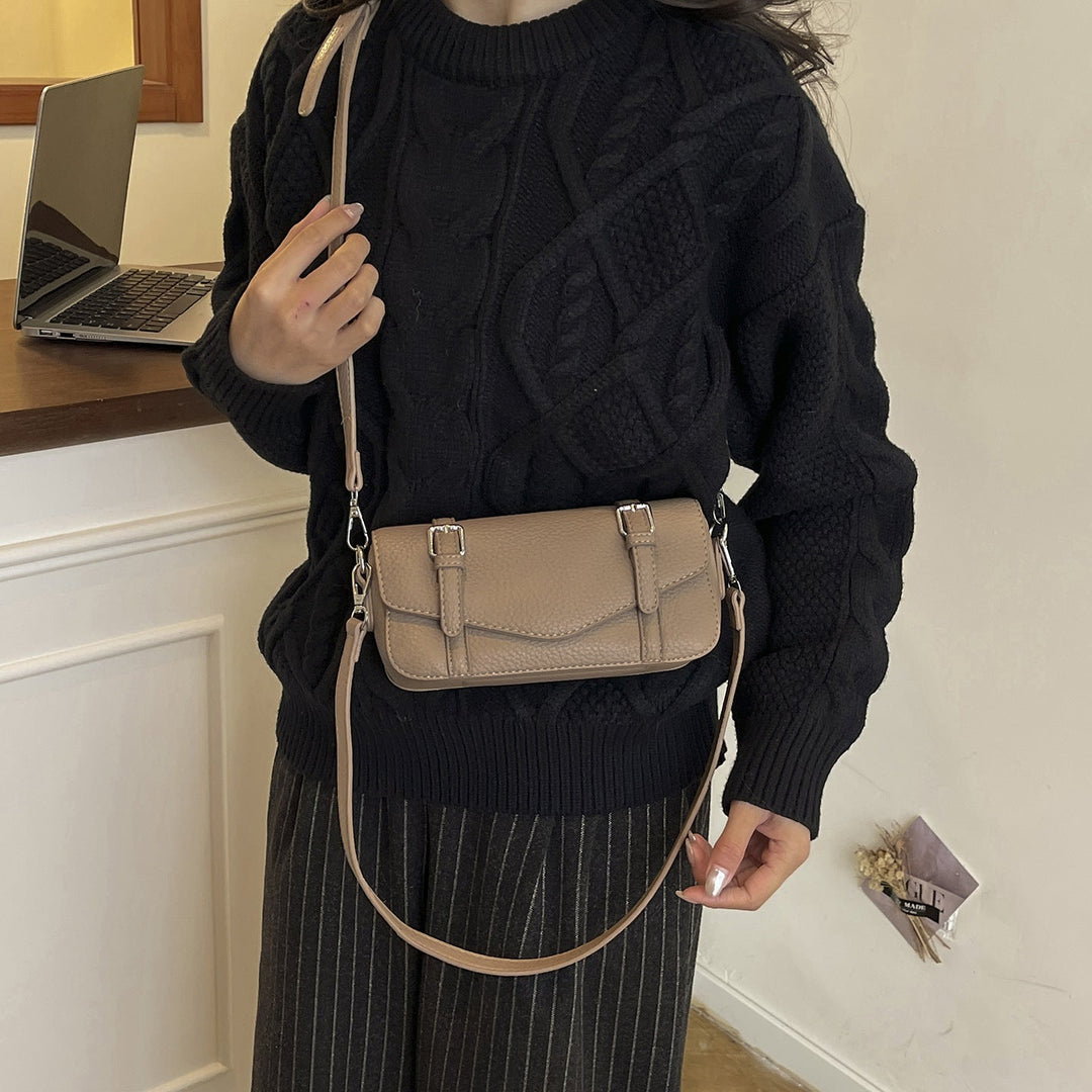 Women's elegant shoulder bag made of textured synthetic leather with adjustable shoulder strap
