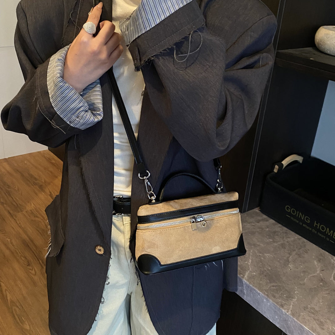 Women's shoulder bag made of soft suede leather with practical compartments