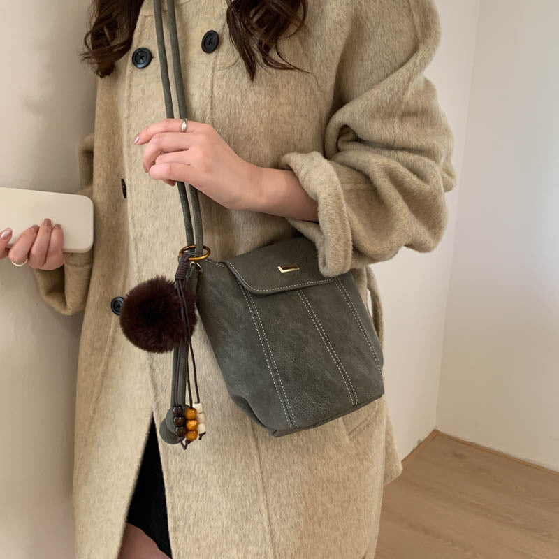 Ladies fashionable crossbody bag with fluffy pendant