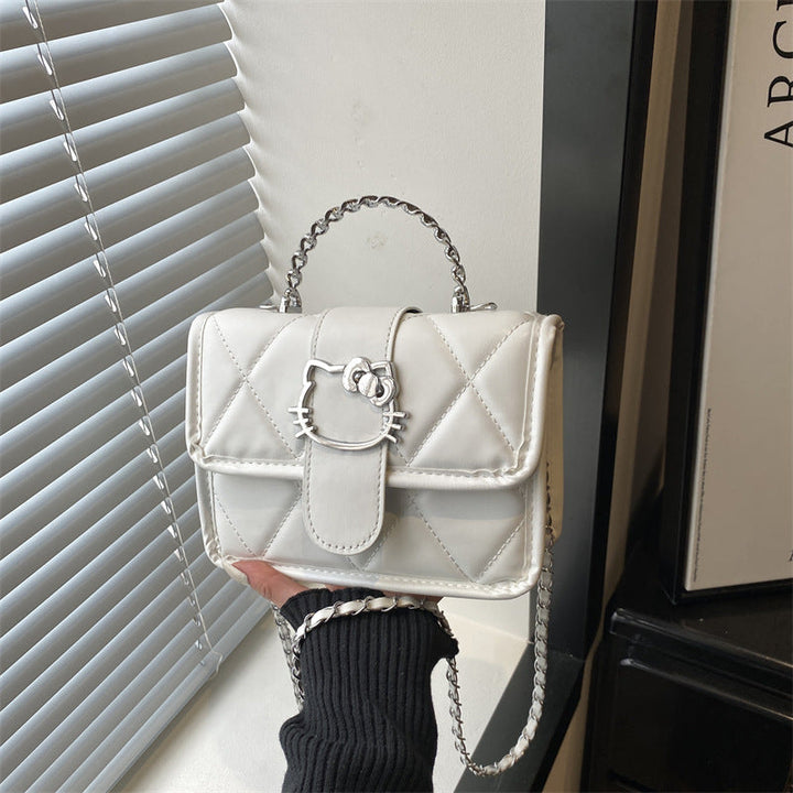Ladies mini handbag with decorative quilting and playful cat motif