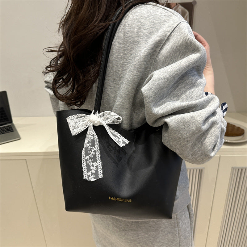 Women’s tote bag made of high-quality synthetic leather with playful bow detail