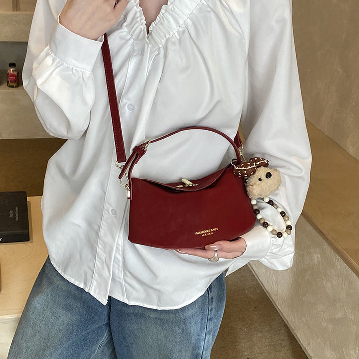 Women's shoulder bag with decorative pendant